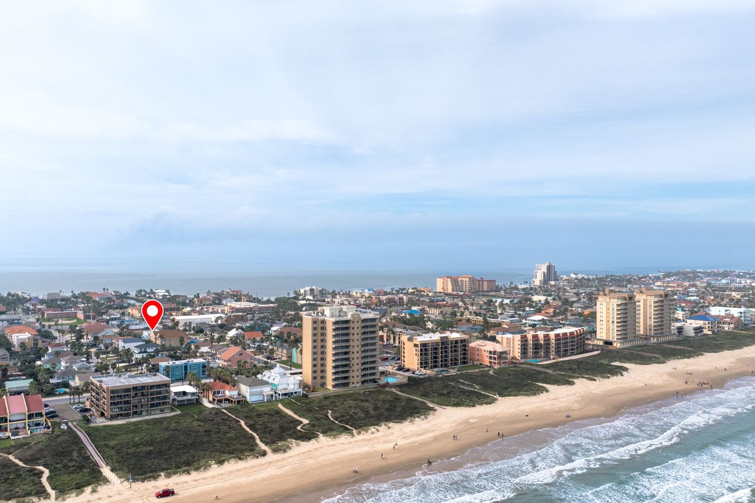 A view of the ocean and beach from above.