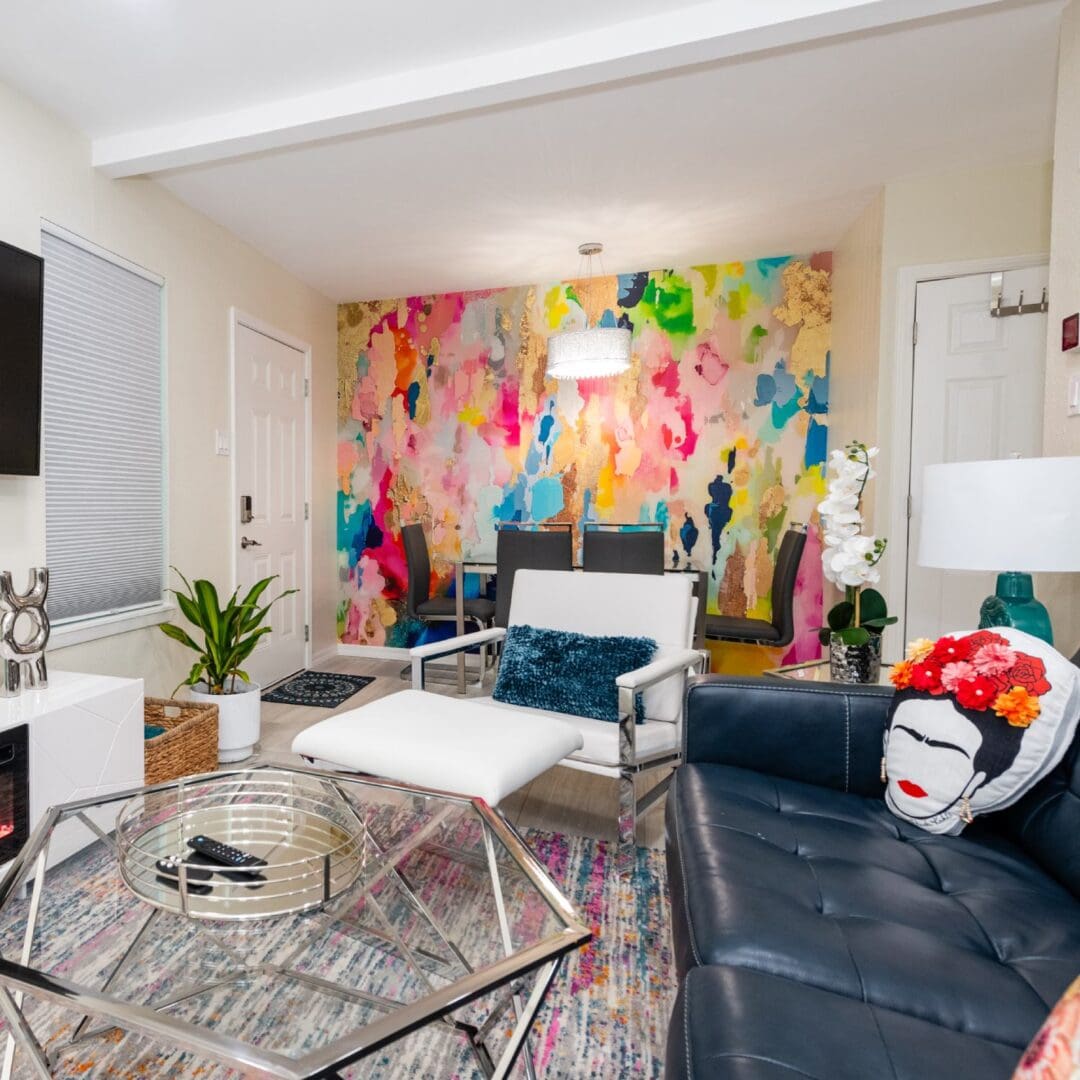 A living room with a couch, chair and table.